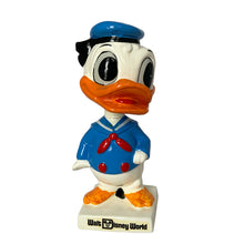 Load image into Gallery viewer, Vintage Walt Disney World Donald Duck paper mache bobble head nodder figurine. Crafted in Japan, 1960s (likely manufactured by Ardco). This beloved collectible along with its nodding head figurine adds a whimsical touch to any room or display. A must-have for any Disney enthusiast. This is a great opportunity for a Disney fan to own a piece of history and to add to their collection.