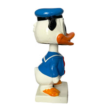 Load image into Gallery viewer, Vintage Walt Disney World Donald Duck paper mache bobble head nodder figurine. Crafted in Japan, 1960s (likely manufactured by Ardco). This beloved collectible along with its nodding head figurine adds a whimsical touch to any room or display. A must-have for any Disney enthusiast. This is a great opportunity for a Disney fan to own a piece of history and to add to their collection.