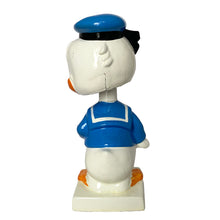 Load image into Gallery viewer, Vintage Walt Disney World Donald Duck paper mache bobble head nodder figurine. Crafted in Japan, 1960s (likely manufactured by Ardco). This beloved collectible along with its nodding head figurine adds a whimsical touch to any room or display. A must-have for any Disney enthusiast. This is a great opportunity for a Disney fan to own a piece of history and to add to their collection.