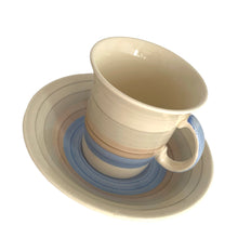 Load image into Gallery viewer, Vintage Art Deco style Wedding Ring coffee set in the blue, rust and gray colourway. Crafted by Susie Cooper, England, 1930s. This kestrel-shaped set comprised of a coffee pot with lid, creamer and sugar with four demitasse cups and saucers.
The set is in generally good vintage condition with no chips, cracks, or repairs. Each piece shows age-related crazing. The coffee pot has a chip at the top of the spout, and the sugar bowl has staining on the bottom. All pieces have maker's marks.