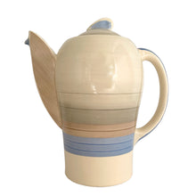 Load image into Gallery viewer, Vintage Art Deco style Wedding Ring coffee set in the blue, rust and gray colourway. Crafted by Susie Cooper, England, 1930s. This kestrel-shaped set comprised of a coffee pot with lid, creamer and sugar with four demitasse cups and saucers.
The set is in generally good vintage condition with no chips, cracks, or repairs. Each piece shows age-related crazing. The coffee pot has a chip at the top of the spout, and the sugar bowl has staining on the bottom. All pieces have maker's marks.