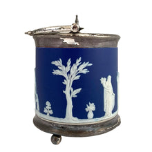 Load image into Gallery viewer, Opposite side view of antique Wedgwood cobalt blue Jasperware biscuit barrel with silver-plated mounts, showing continuous neoclassical relief frieze and hinged lid