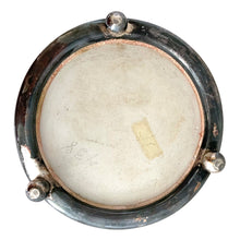 Load image into Gallery viewer, Underside of Wedgwood Jasperware biscuit barrel showing unglazed ceramic base with impressed WEDGWOOD mark, set within silver-plated footed frame with ball feet