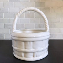 Load image into Gallery viewer, Vintage white ceramic basket planter with rope style handle. Its size and makes it great for creating a mini indoor garden! Marker's mark on the bottom, but it's indecipherable. In excellent condition, free from chips/cracks/repairs. Measures 8 x 9 1/2 inches