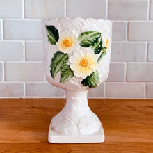 Load image into Gallery viewer, Pretty vintage pedestal planter in white with embossed daisies in white, yellow with green leaves. Produced by Rubens Originals, Japan, circa 1950s. In excellent condition, free from chips/cracks/repairs. Normal crazing present. Measures 4 1/8 x 6 3/4 inches