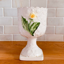 Load image into Gallery viewer, Pretty vintage pedestal planter in white with embossed daisies in white, yellow with green leaves. Produced by Rubens Originals, Japan, circa 1950s. In excellent condition, free from chips/cracks/repairs. Normal crazing present. Measures 4 1/8 x 6 3/4 inches