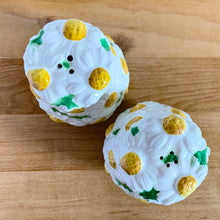 Load image into Gallery viewer, Pretty vintage mid-century hand painted "Daisytime" ceramic salt and pepper shakers featuring an overall pattern of raised white daisy flowers with yellow centres and green leaves. Crafted by PY, Japan, circa 1950s. A pretty addition to any tablescape! In vintage condition, minor flea bites, no cracks/repairs. Original corks are inside with new corks provided. Bottoms marked "Daisytime PY 22648" Measures 2 1/2 x 3 5/8 inches