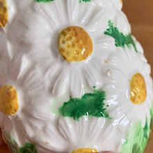 Load image into Gallery viewer, Pretty vintage mid-century hand painted "Daisytime" ceramic salt and pepper shakers featuring an overall pattern of raised white daisy flowers with yellow centres and green leaves. Crafted by PY, Japan, circa 1950s. A pretty addition to any tablescape! In vintage condition, minor flea bites, no cracks/repairs. Original corks are inside with new corks provided. Bottoms marked "Daisytime PY 22648" Measures 2 1/2 x 3 5/8 inches