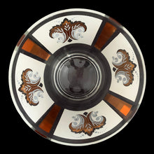 Load image into Gallery viewer, Vintage chip and dip set featuring a white and gold Fleurs-de-lis motif on glass. The set consists of a large main chip bowl and a smaller dip bowl that attaches via a metal gold-toned bracket. Crafted by Anchor Hocking, 1960s. The retro way to serve your favourite snacks at your next party, movie or game night.