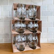 Load image into Gallery viewer, Vintage drinkware featuring a band of white grapevines on feminine flared shaped clear glass in 6, 8 and 10 ounce sets of four. Manufactured by St. Clair Division of Domglas Ltd., Canada, circa 1970s. These glasses are lovely and would make a perfect housewarming gift! In excellent condition, new old stock in original boxes.