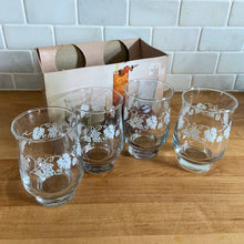 Load image into Gallery viewer, Vintage drinkware featuring a band of white grapevines on feminine flared shaped clear glass in 6, 8 and 10 ounce sets of four. Manufactured by St. Clair Division of Domglas Ltd., Canada, circa 1970s. These glasses are lovely and would make a perfect housewarming gift! In excellent condition, new old stock in original boxes.