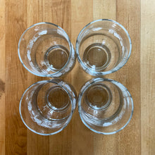 Load image into Gallery viewer, Vintage drinkware featuring a band of white grapevines on feminine flared shaped clear glass in 6, 8 and 10 ounce sets of four. Manufactured by St. Clair Division of Domglas Ltd., Canada, circa 1970s. These glasses are lovely and would make a perfect housewarming gift! In excellent condition, new old stock in original boxes.