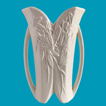 Load image into Gallery viewer, Exceptionally beautiful vintage matte white Butterfly Line vase, features clusters of butterflies on the front and back, a unique split foot and strap handles. Crafted by McCoy Pottery, early 1940s. This rare vase must for any art pottery collector!
In excellent vintage condition, no chips, no cracks, no repairs, crazing commensurate with age. Impressed 'USA' mark on the split foot.
Measures 6 1/2 x 5 1/2 x 10 3/8 inches