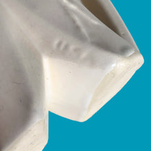 Load image into Gallery viewer, Exceptionally beautiful vintage matte white Butterfly Line vase, features clusters of butterflies on the front and back, a unique split foot and strap handles. Crafted by McCoy Pottery, early 1940s. This rare vase must for any art pottery collector!
In excellent vintage condition, no chips, no cracks, no repairs, crazing commensurate with age. Impressed 'USA' mark on the split foot.
Measures 6 1/2 x 5 1/2 x 10 3/8 inches