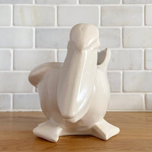Load image into Gallery viewer, Vintage mid-century era matte white Pelican pattern planter. Crafted by Nelson McCoy Pottery, 1948. Perfect as a succulent planter or to hold baby accessories as part of your nursery decor! This rare piece is must for any art pottery collector.
In excellent vintage condition, no chips/cracks/repairs, age-related crazing and interior staining. Manufacturer's glaze pops. Maker's mark.
Measures 7 3/4 x 4 1/4 x 5 1/2 inches