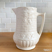 Load image into Gallery viewer, Antique vintage art deco matte white Rosella no. 320 ceramic yellow ware pitcher featuring climbing roses on a basketweave pattern. Crafted by Robinson Ransbottom Pottery Co., USA, 1920s. A beautiful piece of art pottery to add to collection. Makes a wonderful vessel for a floral arrangement.
Option 1: 6 1/2 x 7 5/8 inches
In excellent vintage condition, no chips/cracks/repairs, age-related crazing and typical manufacturing glaze pops. Maker's mark.