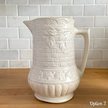 Load image into Gallery viewer, Antique vintage art deco matte white Rosella no. 320 ceramic yellow ware pitcher featuring climbing roses on a basketweave pattern. Crafted by Robinson Ransbottom Pottery Co., USA, 1920s. A beautiful piece of art pottery to add to collection. Makes a wonderful vessel for a floral arrangement.
Option 2: 6 1/2 x 7 5/8 inches
In as found vintage condition, chips to the spout, no cracks/repairs, age-related crazing and typical manufacturing glaze pops. Maker's mark.