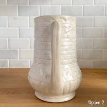 Load image into Gallery viewer, Antique vintage art deco matte white Rosella no. 320 ceramic yellow ware pitcher featuring climbing roses on a basketweave pattern. Crafted by Robinson Ransbottom Pottery Co., USA, 1920s. A beautiful piece of art pottery to add to collection. Makes a wonderful vessel for a floral arrangement.
Option 2: 6 1/2 x 7 5/8 inches
In as found vintage condition, chips to the spout, no cracks/repairs, age-related crazing and typical manufacturing glaze pops. Maker's mark.