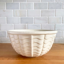 Load image into Gallery viewer, Vintage glossy white ceramic mixing bowl with an exterior pattern of horizontal waves. Crafted by Robinson Ransbottom Pottery Co., USA, 1960s. A beautiful piece to add to your kitchen's art pottery collection!
In excellent condition, no chips/cracks/repairs, wear to the rim. Maker's marks.
Measures 8 1/4 x 4 1/4 inches