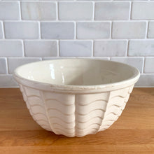 Load image into Gallery viewer, Vintage glossy white ceramic mixing bowl with an exterior pattern of horizontal waves. Crafted by Robinson Ransbottom Pottery Co., USA, 1960s. A beautiful piece to add to your kitchen's art pottery collection!
In excellent condition, no chips/cracks/repairs, wear to the rim. Maker's marks.
Measures 8 1/4 x 4 1/4 inches