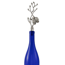 Load image into Gallery viewer, In situu detail of hand-crafted nickel-plated orchid on Michael Aram wine stopper in a blue wine bottle