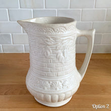 Load image into Gallery viewer, Antique vintage art deco matte white Rosella no. 320 ceramic yellow ware pitcher featuring climbing roses on a basketweave pattern. Crafted by Robinson Ransbottom Pottery Co., USA, 1920s. A beautiful piece of art pottery to add to collection. Makes a wonderful vessel for a floral arrangement.
Option 2: 6 1/2 x 7 5/8 inches
In as found vintage condition, chips to the spout, no cracks/repairs, age-related crazing and typical manufacturing glaze pops. Maker's mark.