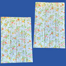 Load image into Gallery viewer, This delightful pair of vintage Wondercale Gardens floral pillowcases features colourful flower blossoms of roses, poppies and morning glories in shades of pink, orange, blue, yellow and green on a white ground. 50% cotton 50% polyester. Crafted by Springmaid, USA, 1976. Add vintage charm to your bedroom with these beauties!
In excellent like-new condition, no stains or tears.
Measures 31 x 20 1/2 inches