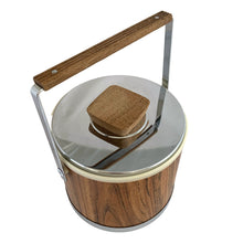 Load image into Gallery viewer, Vintage ice bucket featuring a chrome base, wood grained bucket, topped with a chrome and wood handle and lid; the interior is cream coloured plastic. Crafted by Kromex, USA, circa 1960s. A fabulous example of mid-century design and style!
In used excellent used condition. The handle and knob are in excellent condition. Marked on the bottom with Kromex and Made in the USA.
Measures 8 1/8 x 7 1/4 inches