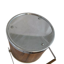 Load image into Gallery viewer, Vintage ice bucket featuring a chrome base, wood grained bucket, topped with a chrome and wood handle and lid; the interior is cream coloured plastic. Crafted by Kromex, USA, circa 1960s. A fabulous example of mid-century design and style!
In used excellent used condition. The handle and knob are in excellent condition. Marked on the bottom with Kromex and Made in the USA.
Measures 8 1/8 x 7 1/4 inches
