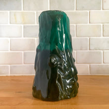 Load image into Gallery viewer, This gorgeous Evangeline pitcher features a stunning design of raised mushrooms and knots around a tree trunk. This sweet pitcher makes for a beautiful statement piece or a functional pitcher for your home. In excellent condition, free from chips/cracks. Measures 3 3/4 x 6 3/8 inches