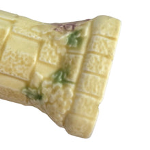 Load image into Gallery viewer, Beautifully detailed, vintage Art Deco Flaxman Ware matte yellow glazed castle tower pitcher featuring a budgie bird atop the handle, along with purple and green florals. Crafted by Wade, Heath & Co., England, 1930s. This decorative and highly collectible piece makes a lovely decor accent.
In good vintage condition with chip on the bottom of the foot, typical crazing. Maker's mark on the bottom.
Measures 5 x 4 x 7 3/4 inches