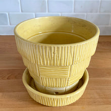 Load image into Gallery viewer, Highly collectible vintage mid-century yellow basketweave ceramic art pottery planter with attached underplate. Crafted by McCoy Pottery, 1950s. The perfect home for your favourite houseplant or succulent!
In excellent vintage condition, no chips/cracks/repairs, age-related crazing. Maker's mark.
Measures 6 3/8 x 5 1/2 inches