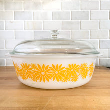 Load image into Gallery viewer, Vintage Glasbake milk glass round lidded 3 quart casserole dish featuring the "Daisy Days" pattern in yellow, with a clear lid. Manufactured either by the McKee or Jeannette Glass Company in the USA, circa 1960s Perfect for storing, serving, and cooking!