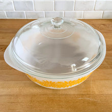 Load image into Gallery viewer, Vintage Glasbake milk glass round lidded 3 quart casserole dish featuring the "Daisy Days" pattern in yellow, with a clear lid. Manufactured either by the McKee or Jeannette Glass Company in the USA, circa 1960s Perfect for storing, serving, and cooking!