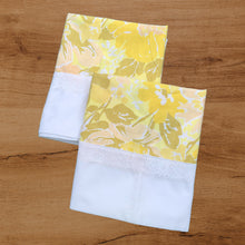 Load image into Gallery viewer, Pair of vintage Truprest yellow floral pillowcases featuring a white border with lace detail. 50% cotton 50% polyester. Crafted by Texmade, Canada, 1970s. Add vintage charm to your bedroom with these beauties! In excellent, like-new condition, no stains or tears. Measures 21x 32 inches