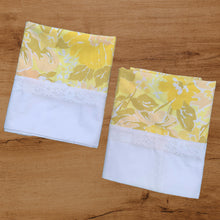 Load image into Gallery viewer, Pair of vintage Truprest yellow floral pillowcases featuring a white border with lace detail. 50% cotton 50% polyester. Crafted by Texmade, Canada, 1970s. Add vintage charm to your bedroom with these beauties! In excellent, like-new condition, no stains or tears. Measures 21x 32 inches