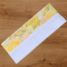 Load image into Gallery viewer, Pair of vintage Truprest yellow floral pillowcases featuring a white border with lace detail. 50% cotton 50% polyester. Crafted by Texmade, Canada, 1970s. Add vintage charm to your bedroom with these beauties! In excellent, like-new condition, no stains or tears. Measures 21x 32 inches