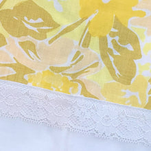 Load image into Gallery viewer, Pair of vintage Truprest yellow floral pillowcases featuring a white border with lace detail. 50% cotton 50% polyester. Crafted by Texmade, Canada, 1970s. Add vintage charm to your bedroom with these beauties! In excellent, like-new condition, no stains or tears. Measures 21x 32 inches