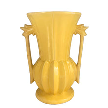 Load image into Gallery viewer, Exceptionally beautiful vintage gloss yellow art deco vase, features a melon base flowing into a trumpet shape finished with leaf topped handles. Crafted by McCoy Pottery, 1948. This rare vase must for any art pottery collector!
In as found vintage condition, no chips//repairs. There is a tight hairline crack on one of the handles and age-related crazing commensurate. Maker's mark on the bottom.
Measures 7 x 9 1/8 inches