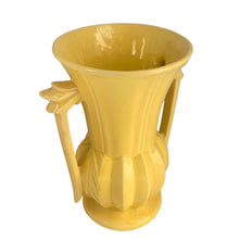 Load image into Gallery viewer, Exceptionally beautiful vintage gloss yellow art deco vase, features a melon base flowing into a trumpet shape finished with leaf topped handles. Crafted by McCoy Pottery, 1948. This rare vase must for any art pottery collector!
In as found vintage condition, no chips//repairs. There is a tight hairline crack on one of the handles and age-related crazing commensurate. Maker's mark on the bottom.
Measures 7 x 9 1/8 inches