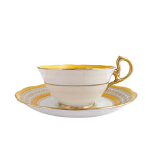 Load image into Gallery viewer, This antique bone china footed teacup and saucer is so sweet! Both the cup and saucer have a lovely scalloped edge, hand painted gold gilt bands over yellow and white glazed porcelain and a gold gilt infinity ribbon dotted in orange. Produced by Royal Albert Crown China, England. Based on the maker's mark, dates to 1927 - 1935. In excellent condition, free from chips, cracks or repairs. Maker's mark on the bottom of both pieces. Teacup is marked with the number 591.