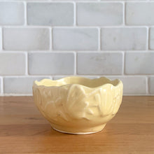 Load image into Gallery viewer, Vintage Art Deco matte yellow glazed Butterfly Line console bowl. Crafted by Nelson McCoy Pottery, early 1940s. This rare piece is must for any McCoy art pottery collector!
In excellent vintage condition, no chips/cracks/repairs. Maker's mark.
Measures 5 1/8 x 3 7/8 x 2 inches