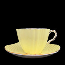 Load image into Gallery viewer, Side profile of vintage EB Foley 1850 scalloped bone china teacup, yellow with floral motif and gold gilt