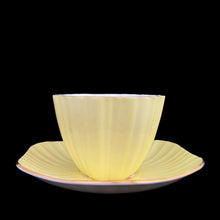 Load image into Gallery viewer, Front view of vintage EB Foley 1850 scalloped bone china teacup, yellow with floral motif and gold gilt