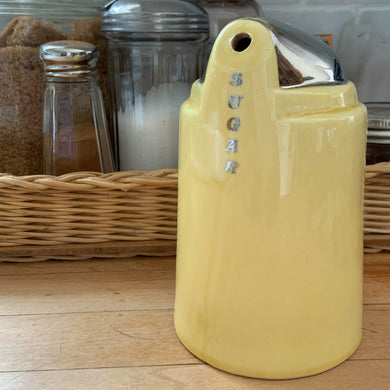 Fantastic vintage Art Deco style yellow and silver ceramic sugar dispenser, featuring the word 