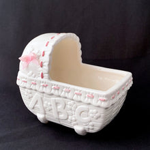 Load image into Gallery viewer, Vintage white and pink ABC bassinet ceramic planter. Crafted by China Ceramic Co., Taiwan, 1970s/80s. Imported by MY-NEIL of Cincinnati, Ohio. Use as a planter, as nursery decor or to store your baby's lotions and accessories. It is simply adorable and the perfect gender reveal accessory to announce your baby is coming into the world!
The ceramics are in excellent condition, no chips or cracks. Measures 5 3/4 x 3 3/4 x 5 1/4 inches