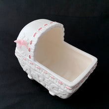 Load image into Gallery viewer, Vintage white and pink ABC bassinet ceramic planter. Crafted by China Ceramic Co., Taiwan, 1970s/80s. Imported by MY-NEIL of Cincinnati, Ohio. Use as a planter, as nursery decor or to store your baby's lotions and accessories. It is simply adorable and the perfect gender reveal accessory to announce your baby is coming into the world!
The ceramics are in excellent condition, no chips or cracks. Measures 5 3/4 x 3 3/4 x 5 1/4 inches