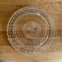 Load image into Gallery viewer, Meet your dessert's new best friend—a charming vintage glass cake plate and dome from the golden age of the mid 20th century. This pressed glass beauty pairs a decorative floral starburst base with a gleaming chrome dome topped by a chic black bakelite knob. Crafted by Federal Glass, USA, 1950s. The plate's fitted rim keeps the lid in place, locking in freshness while your cakes and treats steal the spotlight.
In excellent condition. Plate 11 3/8 x 1/2 inches. Dome 10 x 5 inches.