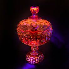 Load image into Gallery viewer, Gorgeous vintage pressed glass amberina Moon and Stars pedestal lidded compote or candy dish. Crafted by the LE Smith Glass Company between 1940s – 2004. This beauty glows brilliantly under black light. This classic candy dish will make a fabulous addition to your glass collection.
In as found vintage condition. The compote is in excellent condition, no chips. The lid has chipping at the rim in several places, see photos.
Measures 6 3/8 x 10 inches