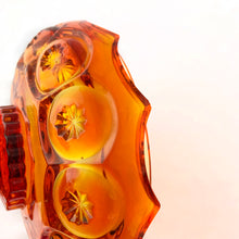 Load image into Gallery viewer, Gorgeous vintage pressed glass amberina Moon and Stars pedestal lidded compote or candy dish. Crafted by the LE Smith Glass Company between 1940s – 2004. This beauty glows brilliantly under black light. This classic candy dish will make a fabulous addition to your glass collection.
In as found vintage condition. The compote is in excellent condition, no chips. The lid has chipping at the rim in several places, see photos.
Measures 6 3/8 x 10 inches